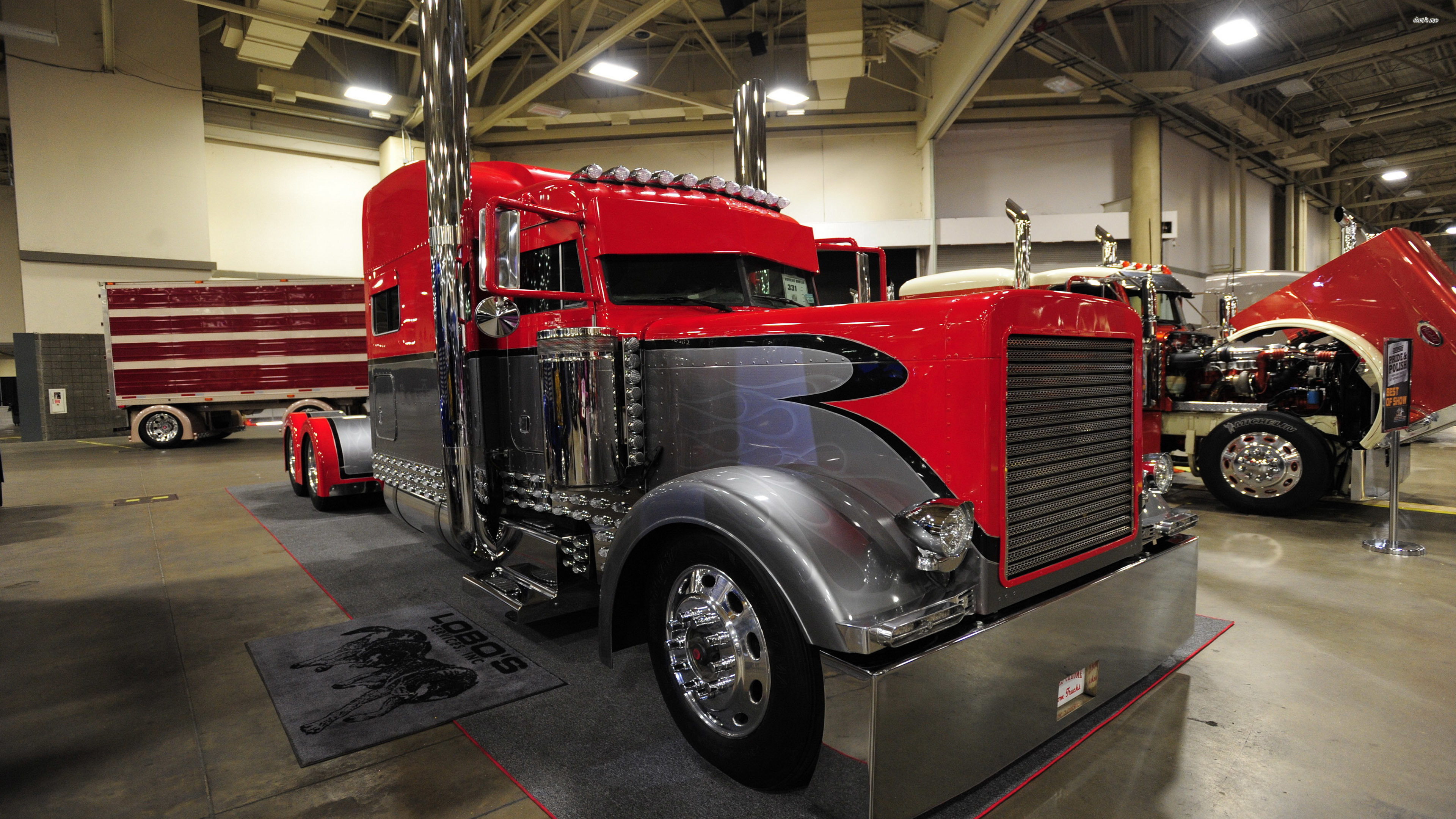 Download Red Peterbilt Truck In A Showroom Wallpaper On Itl.cat